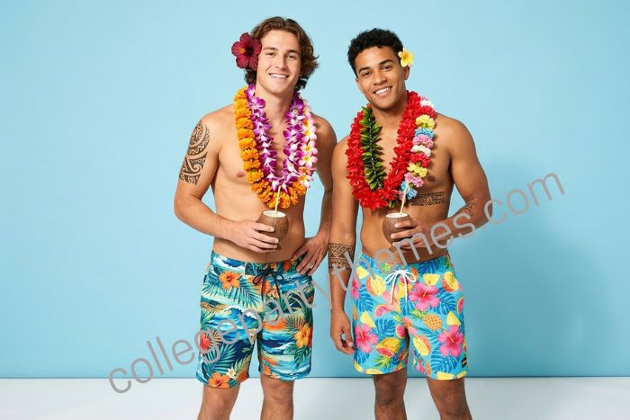 College guy shirtless wearing board shorts stacked flower leis Hawaiian tribal tattoos luau party