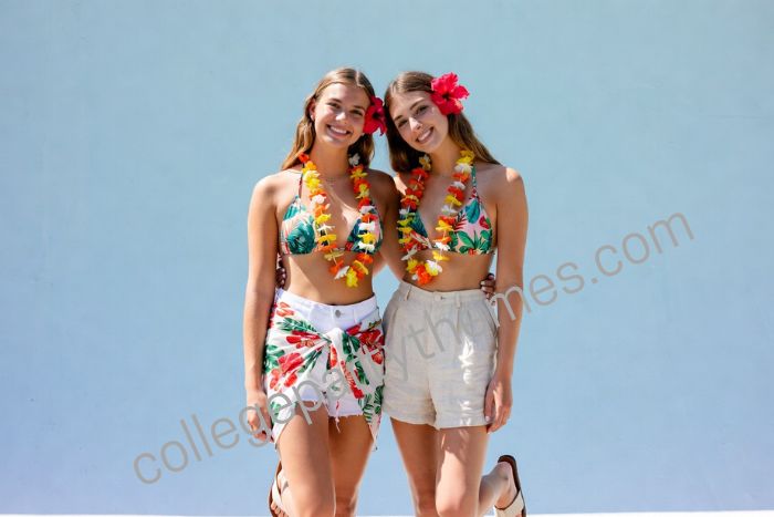 College girl wearing tropical print bikini top white shorts floral sarong flower lei luau party